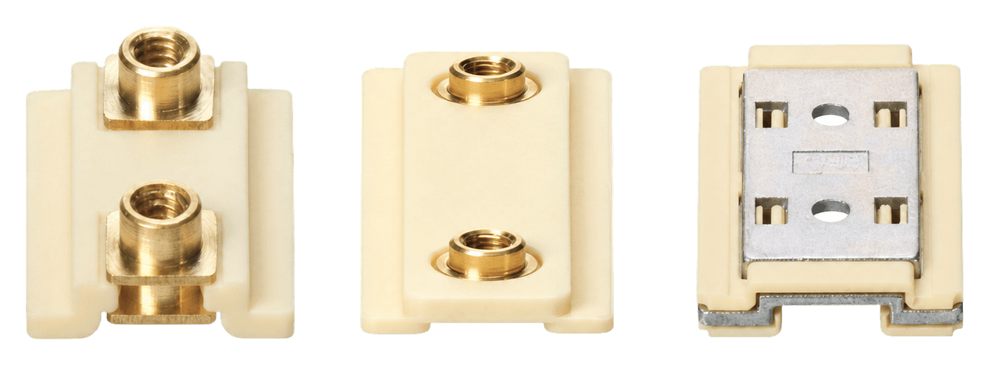 Injection-molded slider components with brass inserts